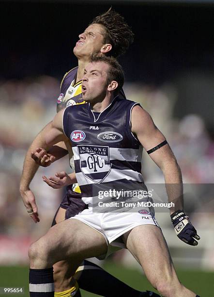 David Mensch for Geelong blocks Michael Gardiner for the West Coast Eagles, in the match between the West Coast Eagles and the Geelong Cats, during...