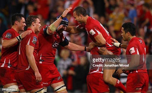 Quade Cooper of the Reds celebrates victory with team mates in the round 14 Super 14 match between the Reds and the Highlanders at Suncorp Stadium on...