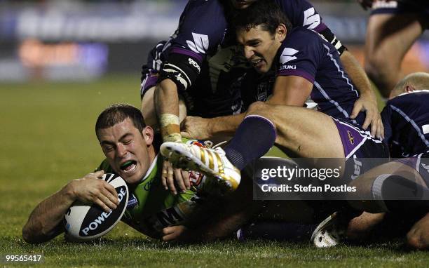 Terry Campese of the Raiders is stopped short of the try line by the Storm defence during the round ten NRL match between the Canberra Raiders and...
