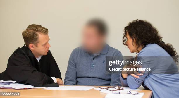 The 32-year-old Italian defendant sits next to his lawyer Dennis Doerdrechter and an interpreter in a court room at the district court Altona in...