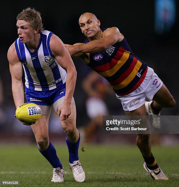 Jack Ziebell of the Kangaroos is tackled by Tyson Edwards of the Crows during the round eight AFL match between the North Melbourne Kangaroos and the...