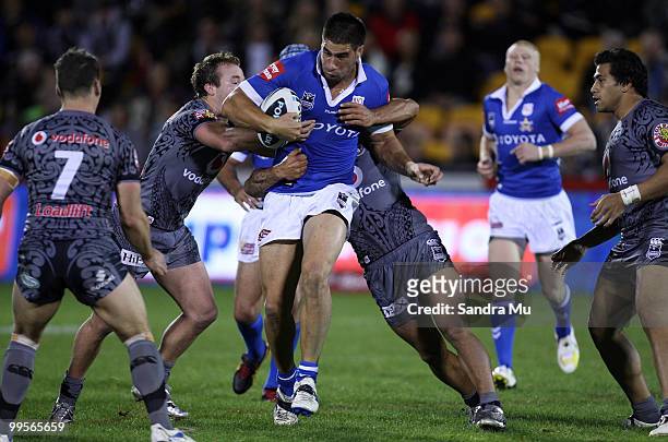 James Tamou of the Cowboys is tackled during the round 10 NRL match between the Warriors and the North Queensland Cowboys at Mt Smart Stadium on May...