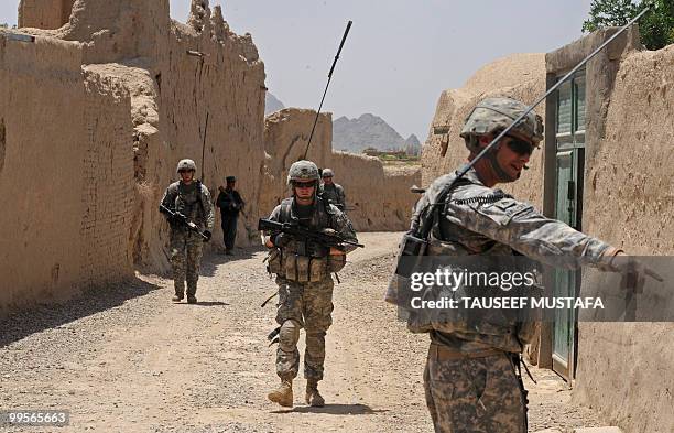 Soldiers from Bravo Troop 1-71 CAV walk on patrol in Belanday village, Dand district in Kandahar on May 15, 2010. NATO and the United States are...