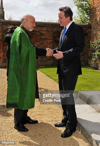 Prime Minister David Cameron shakes hands with Aghan President Hamid Karzai, at Chequers, on May 15, 2010 in Ellesborough, England. The talks,...