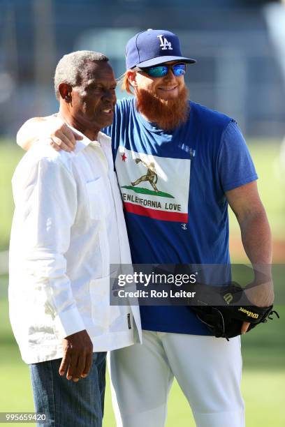 Manny Mota and Justin Turner of the Los Angeles Dodgers pose for a picture before the game against the Chicago Cubs at Dodger Stadium on June 27,...