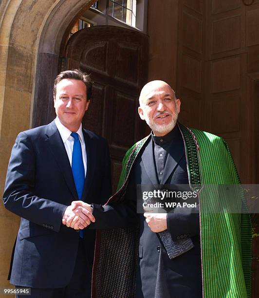 Prime Minister David Cameron shakes hands with Aghan President Hamid Karzai, at Chequers, on May 15, 2010 in Ellesborough, England. The talks,...