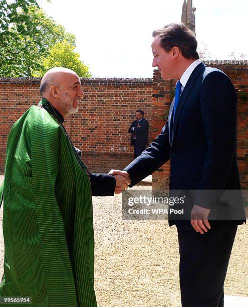 Prime Minister David Cameron shakes hands with Aghan President Hamid Karzai, at Chequers, on May 15, 2010 in Ellesborough, England. The talks,...