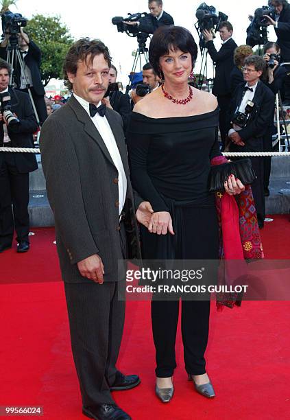 French actress Anny Duperey and her husband Chris Campion pose for photographers as they arrive at the palais des festivals to attend the gala...