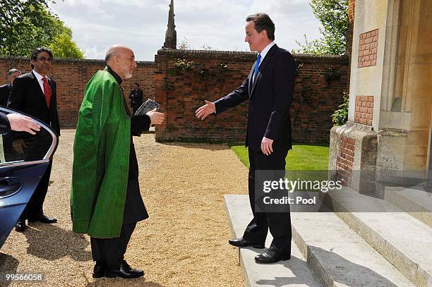 Prime Minister David Cameron shakes hands with Aghan President Hamid Karzai, at Chequers, on May 15, 2010 in Ellesborough, England. The talks,...