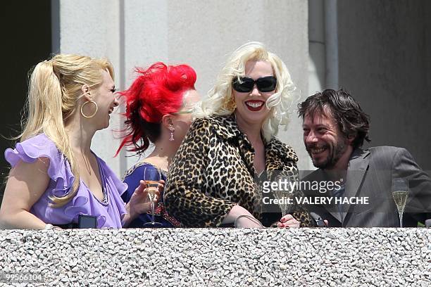 Actresses Julie Atlas Muz, Dirty Martini and Mimi Le Meaux playing in the film of French director and actor Mathieu Amalric "On Tour" drink champagne...