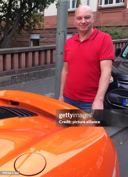 Markus Zahn stands behind his orange sports car and points where a donkey is said to have bitten in Giessen, Germany, 28 September 2017. The bite...