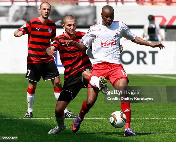 Dramane Traore of FC Lokomotiv Moscow battles for the ball with Vitaliy Fedoriv of FC Amkar Perm during the Russian Football League Championship...