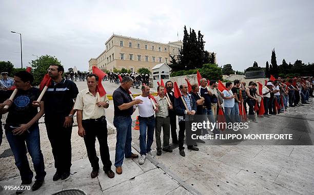 Comunist demonstrators of the KKE stand infront of the Greek parliament on May 15, 2010 to protest against the Government. The austerity package...