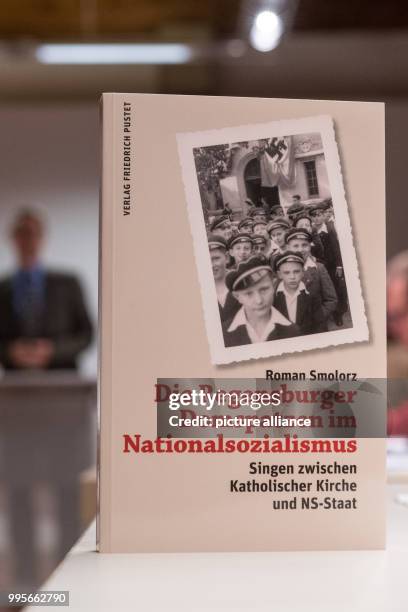 The book titled 'Regensburger Domspatzen im Nationalsozialismus - Singen zwischen Katholischer Kirche und NS-Staat' (lit. 'Regensburg Cathedral Choir...