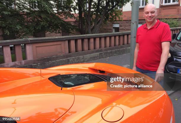 Markus Zahn stands behind his orange sports car and points where a donkey is said to have bitten in Giessen, Germany, 28 September 2017. The bite...