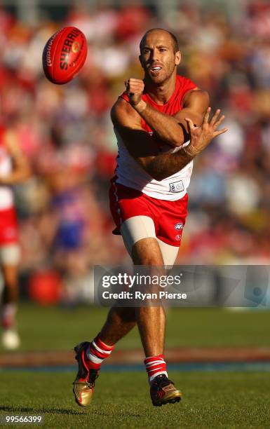 Jarrad McVeigh of the Swans handballs during the round eight AFL match between the Western Bulldogs and the Sydney Swans at Manuka Oval on May 15,...