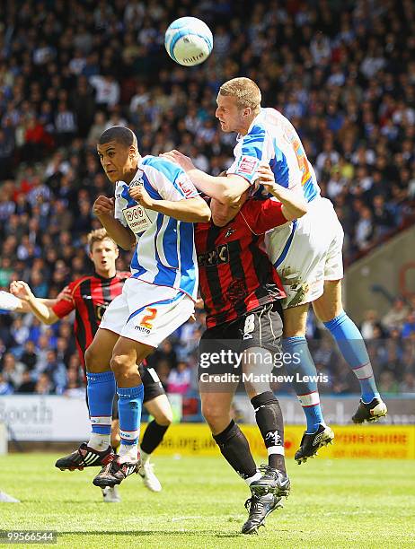 Lee Peltier and Peter Clarke of Huddersfield challenge for the ball with Gary Alexander of Millwall during the Coca-Cola League One Playoff Semi...