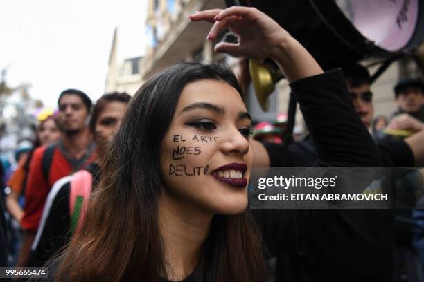 Street artist takes part in a demonstration in front of the Buenos Aires City Legislature in the Argentine capital on July 10 rejecting a bill that...