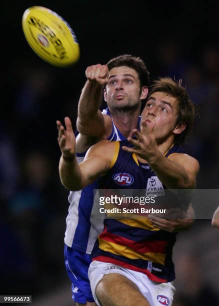 Richard Douglas of the Crows and Bradley Rawlings of the Kangaroos compete for the ball during the round eight AFL match between the North Melbourne...