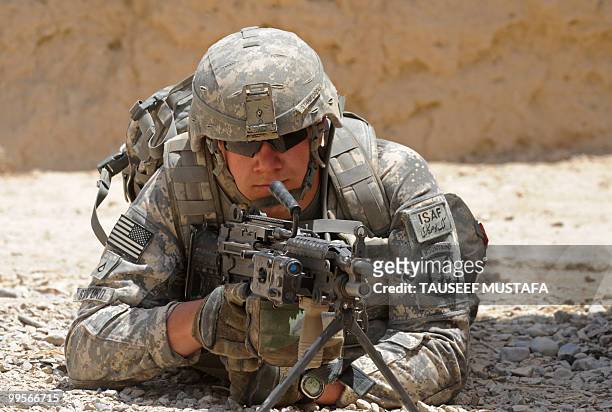 Soldier from Bravo Troop 1-71 CAV patrols through Belanday village, Dand district in Kandahar on May 15, 2010. NATO and the United States are...