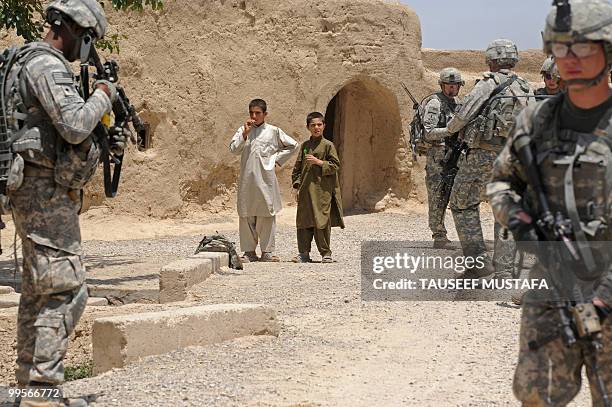 Soldiers from Bravo Troop 1-71 CAV walk on patrol in Belanday village, Dand district in Kandahar on May 15, 2010. NATO and the United States are...