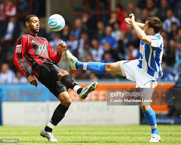 Liam Trotter of Millwall and Antony kay of Huddersfield challenge for the ball during the Coca-Cola League One Playoff Semi Final 1st Leg match...