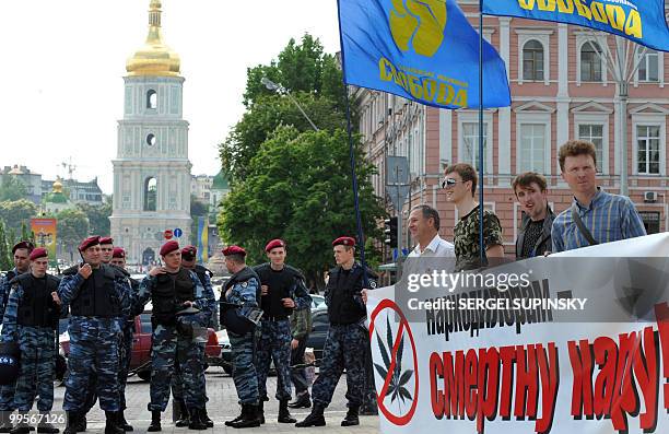 Riot policemen guard activists of Ukrainian ultra-nationalist party Svoboda standing in central Kiev on May 15 to prevent "March of Freedom". The...