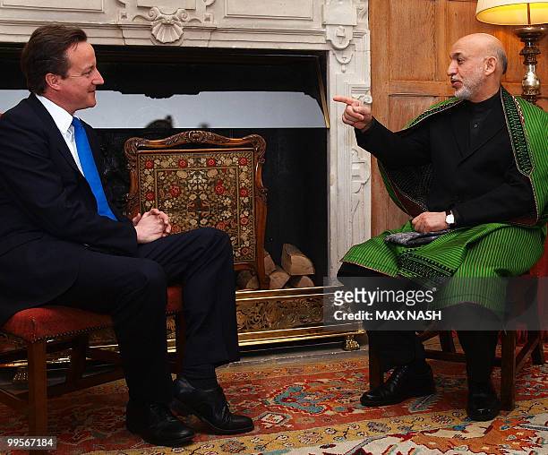 Britain's Prime Minister David Cameron listens at the start of his meeting with Afganistan's President Karzai in the Prime Minister's country...