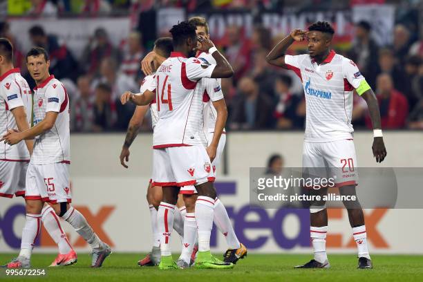 Belgrade's Richmond Boakye and Mitchell Donald cheers over the former's 0-1 score during the Europa League match between 1.FC Cologne vs. Red Star...