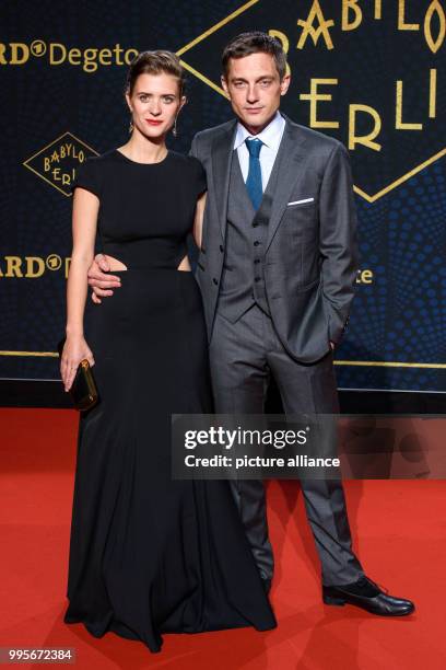 Actors Liv Lisa Fries and Volker Bruch arrive, walking over the red carpet for the premiere of the TV series "Babylon Berlin" of the channel ARD, in...