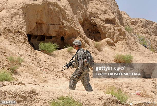 Soldier from Bravo Troop 1-71 CAV walks on patrol near Belanday village, Dand district in Kandahar on May 15, 2010. NATO and the United States are...