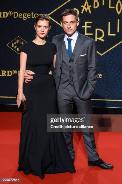 Actors Liv Lisa Fries and Volker Bruch arrive, walking over the red carpet for the premiere of the TV series "Babylon Berlin" of the channel ARD, in...