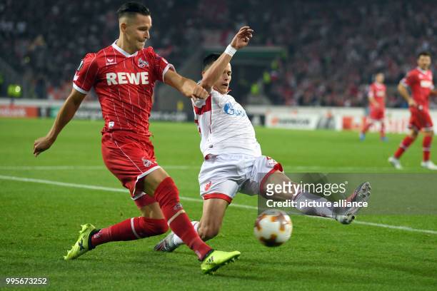 Belgrade's Nemanja Radonjic and Cologne's Pawel Olkowski vie for the ball during the Europa League match between 1.FC Cologne vs. Red Star Belgrade...