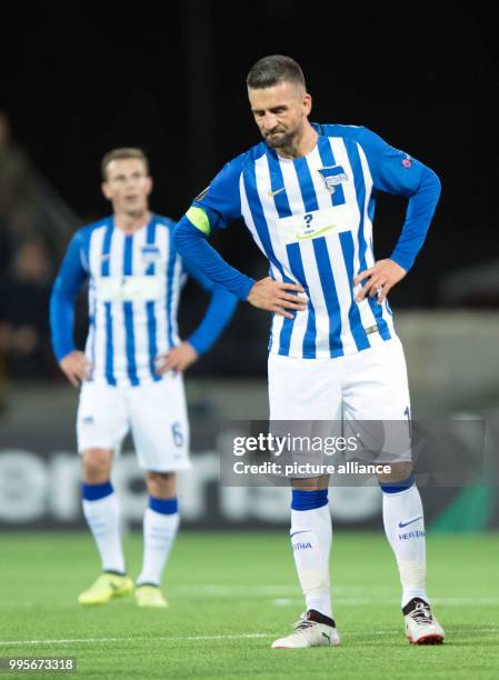 Hertha's Vladimir Darida and Vedad Ibisevic stand dejected after the Europa League match between Ostersunds FK and Hertha BSC at the Jaemtkraft Arena...