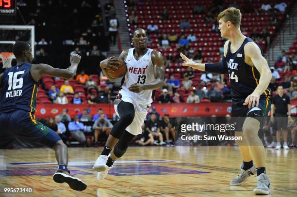 Bam Adebayo of the Miami Heat drives against Thomas Wilder and Isaac Haas of the Utah Jazz during the 2018 NBA Summer League at the Thomas & Mack...
