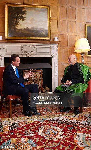 Britain's Prime Minister David Cameron gestures during a meeting with Afganistan's President Hamid Karzai in the Prime Minister's country residence...