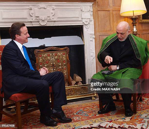 Britain's Prime Minister David Cameron attends a meeting with Afganistan's President Hamid Karzai in the Prime Minister's country residence of...