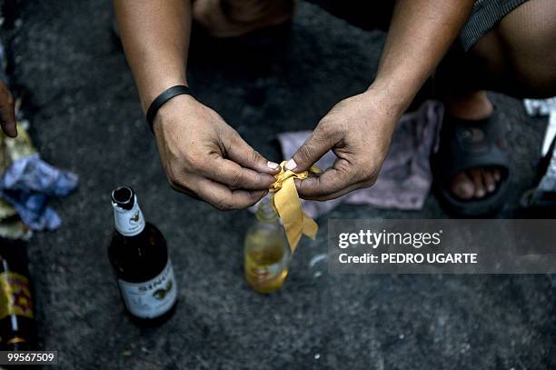Demonstrator prepares a molotov cocktail during clashes in Bangkok on May 15, 2010. Six people were killed and 31 injured in fresh violence as troops...