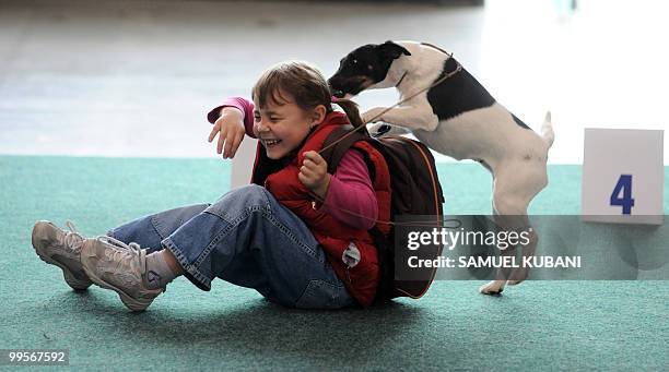 Child plays with her dog on May 15, 2010 during the Spring Danube International Dogs Exhibition in Bratislava.The event takes place until May 16, and...