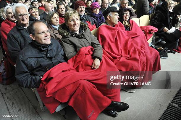 People wrap up in blankets as they attend the premiere of Oberammergau's Passion Play on May 15, 2010. The Oberammergau Passion Play, first staged in...