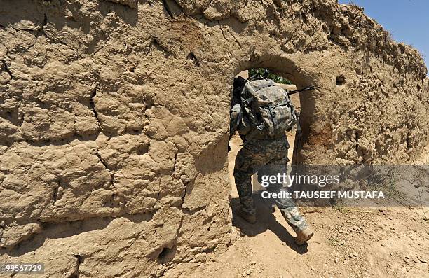 Soldier from Bravo Troop 1-71 CAV walks on patrol in Belanday village, Dand district in Kandahar on May 15, 2010. NATO and the United States are...