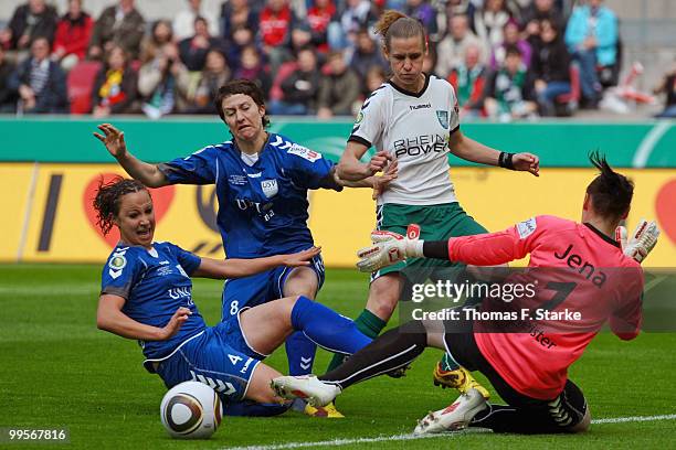 Julia Arnold and Anna Hoefer of Jena, Simone Laudehr of Duisburg and Jana Burmeister of Jena in action during the DFB Women's Cup final match between...
