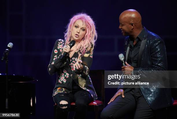 The singer Cyndi Lauper and the moderator Yared Dibaba speak on stage of the Operettenhaus during a press showing of the musical "Kinky Boots" in...