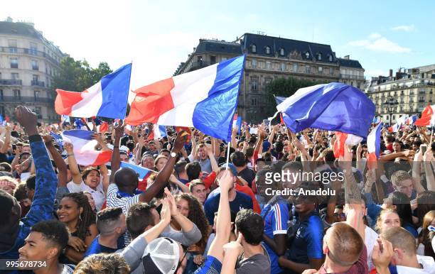 Supporters of France football national team celebrate their team's victory against Belgium of the semifinal match in the FIFA 2018 World Cup in front...