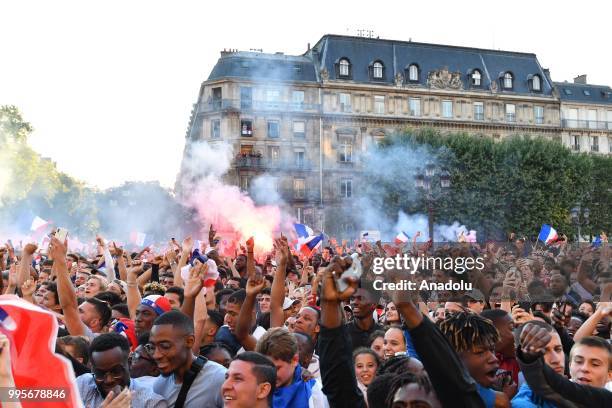 Supporters of France football national team celebrate their team's victory against Belgium of the semifinal match in the FIFA 2018 World Cup in front...