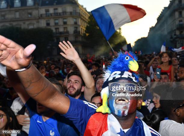 Supporters of France football national team celebrate their team's victory against Belgium of the semifinal match in the FIFA 2018 World Cup in front...