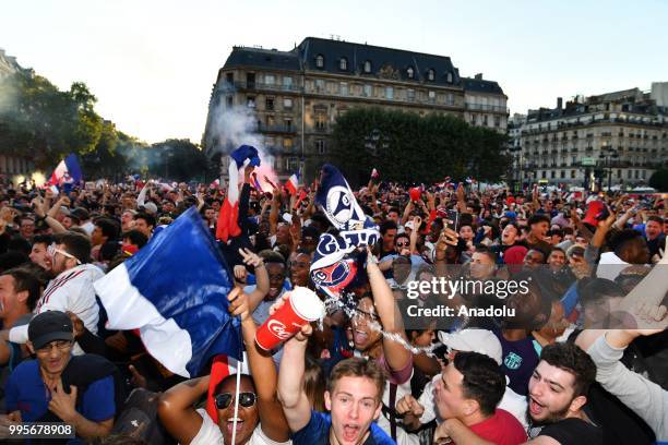 Supporters of France football national team celebrate their team's victory against Belgium of the semifinal match in the FIFA 2018 World Cup in front...