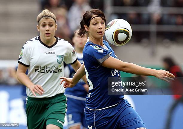 Sylvia Arnold of Jena is challenged by Luisa Wensing of Duisburg during the DFB Women's Cup final match between FCR 2001 Duisburg and FF USV Jena at...