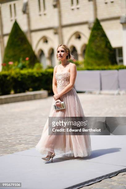 Emma Roberts wears a lace dress , outside Dior, during Paris Fashion Week Haute Couture Fall Winter 2018/2019, on July 2, 2018 in Paris, France.