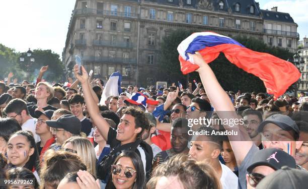 Supporters of France football national team celebrate their team's victory against Belgium of the semifinal match in the FIFA 2018 World Cup in front...